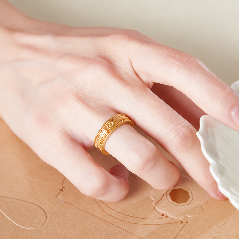 Original model wearing the phoenix ring with hand resting on paper