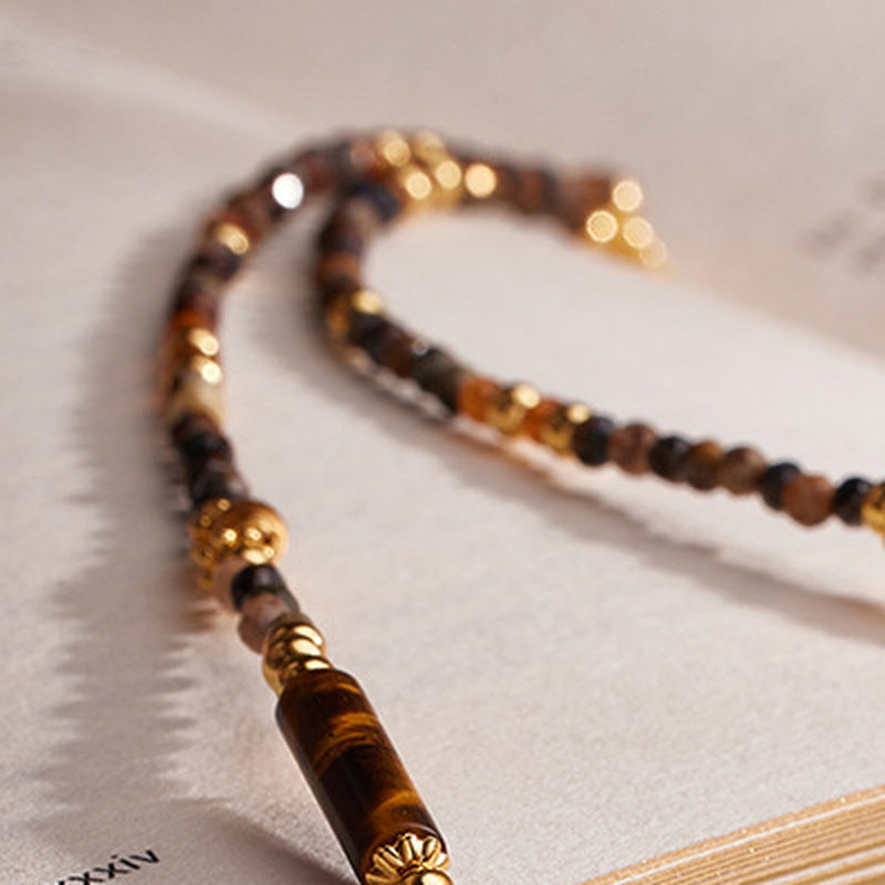 Close view of faceted Pietersite and Orange Garnet beads