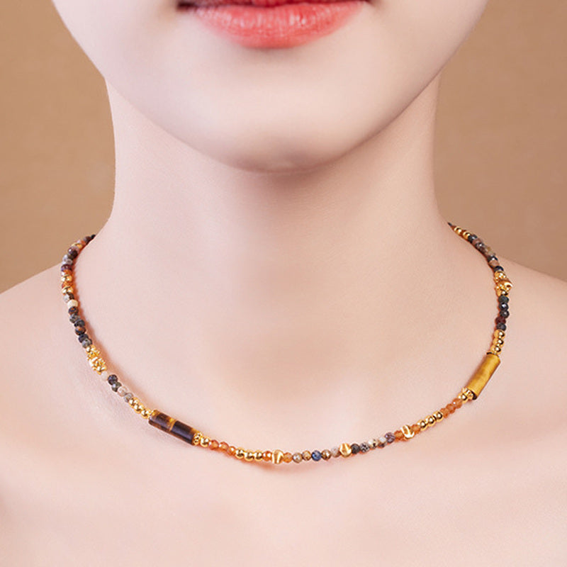 Close model view of the Pietersite and Orange Garnet necklace