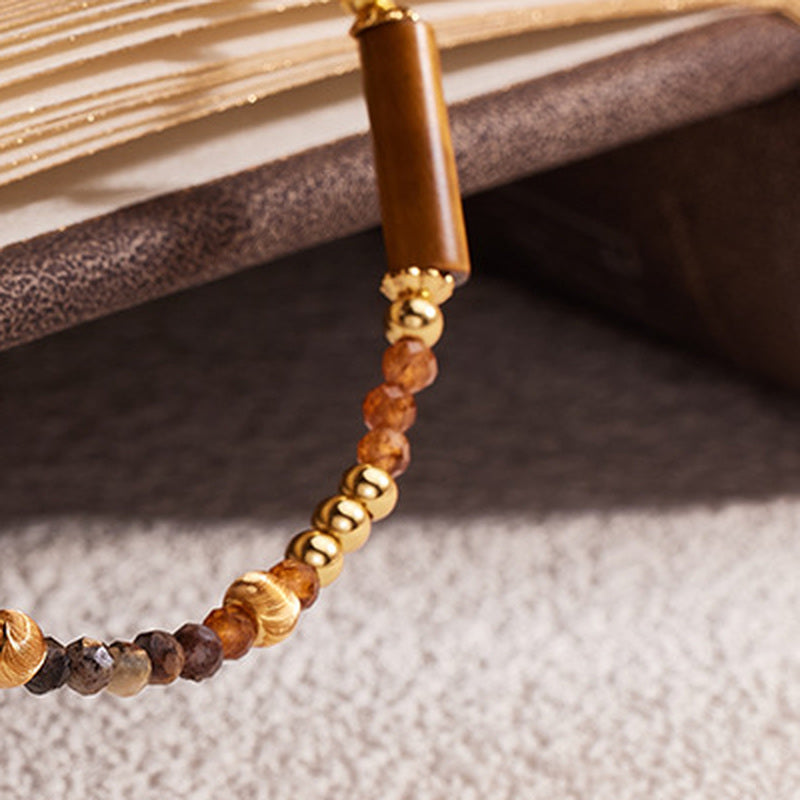 Close view of polished details and earth-toned natural stone beads