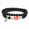 Pink agate gourd and black obsidian double-wrap bracelet on white
