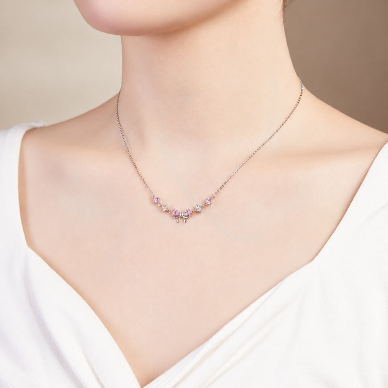 Supplier model wearing the pink bow and star necklace