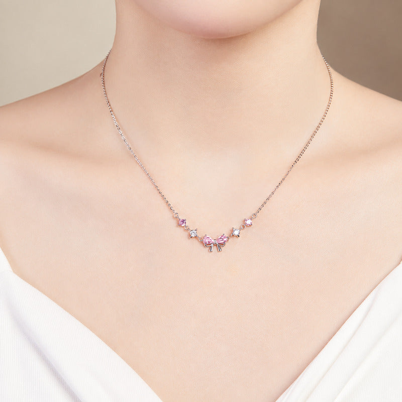 Front-facing supplier model wearing the adjustable pink bow necklace