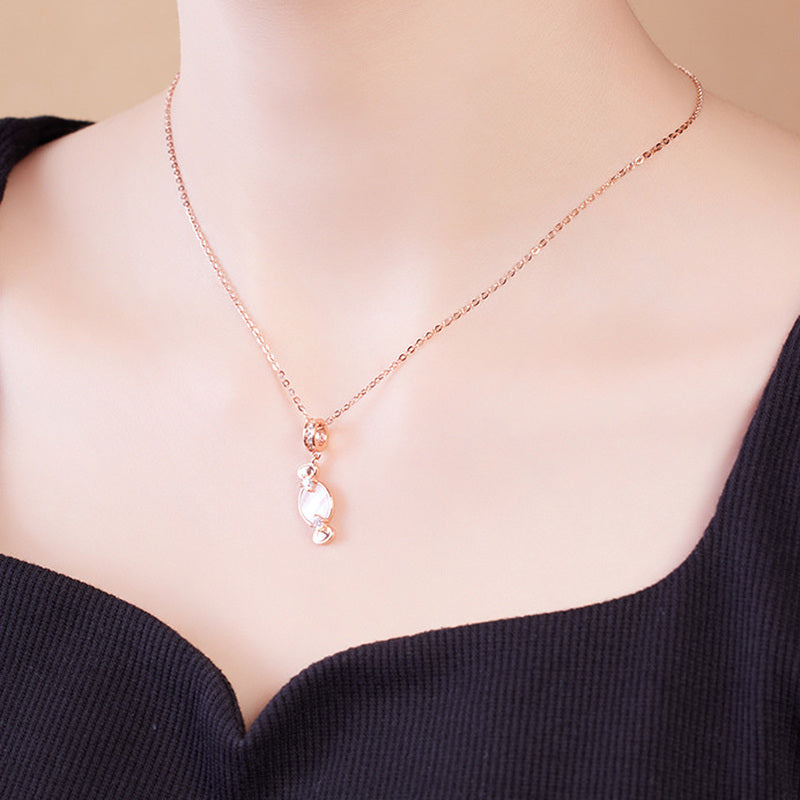 Model wearing pink mother-of-pearl candy pendant necklace