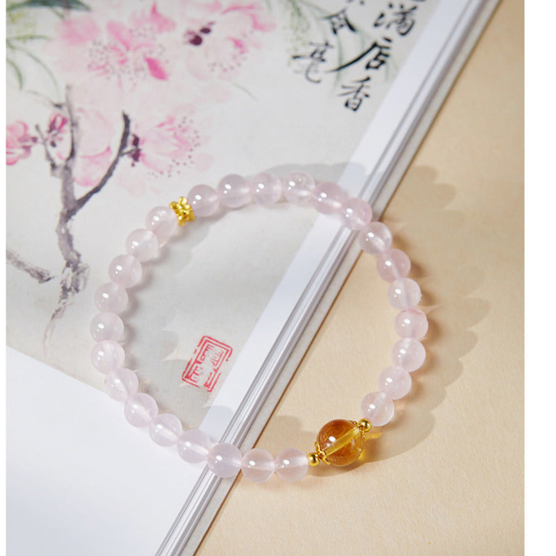 Close view of pink crystal and citrine bracelet details
