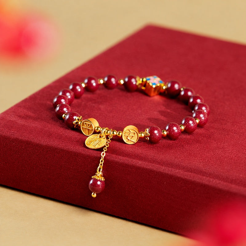 Pressed cinnabar four-leaf clover bracelet on a red fabric book, oblique view
