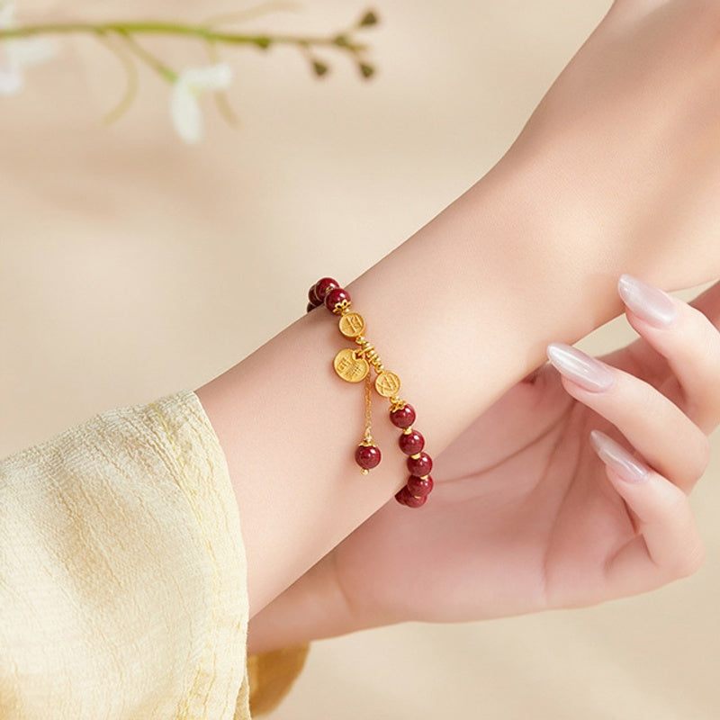 Original model wearing the pressed cinnabar bracelet with peace charms