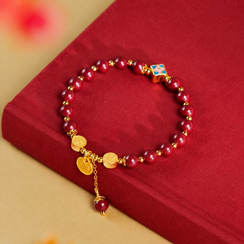 Pressed cinnabar bracelet on a red book, upper product view