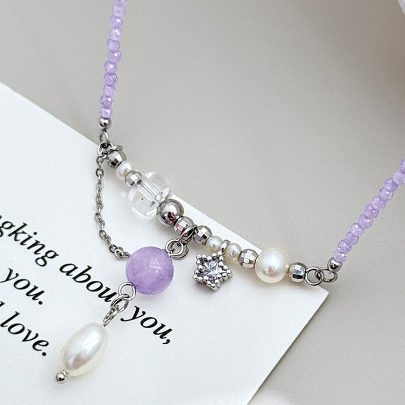 Close-up of amethyst pearl necklace with star charm