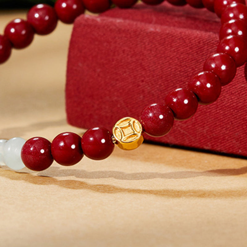 Close detail of S925 silver coin and polished red beads