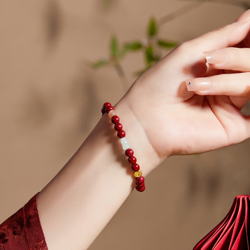 Side angle of model wearing the burgundy bead bracelet