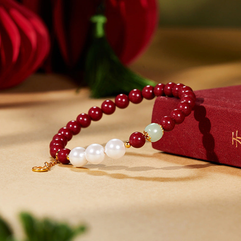Red beaded bracelet styled beside a red box