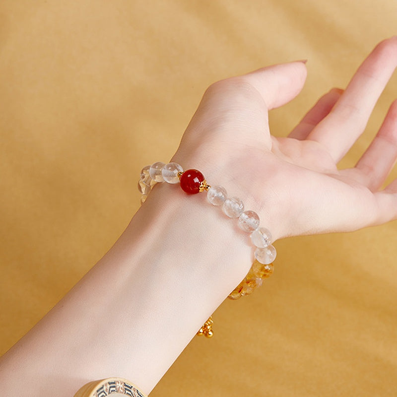Red agate and clear quartz bracelet worn on the wrist