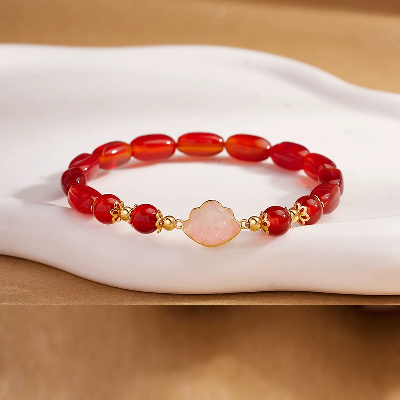 Red agate cloud bracelet on warm ivory display