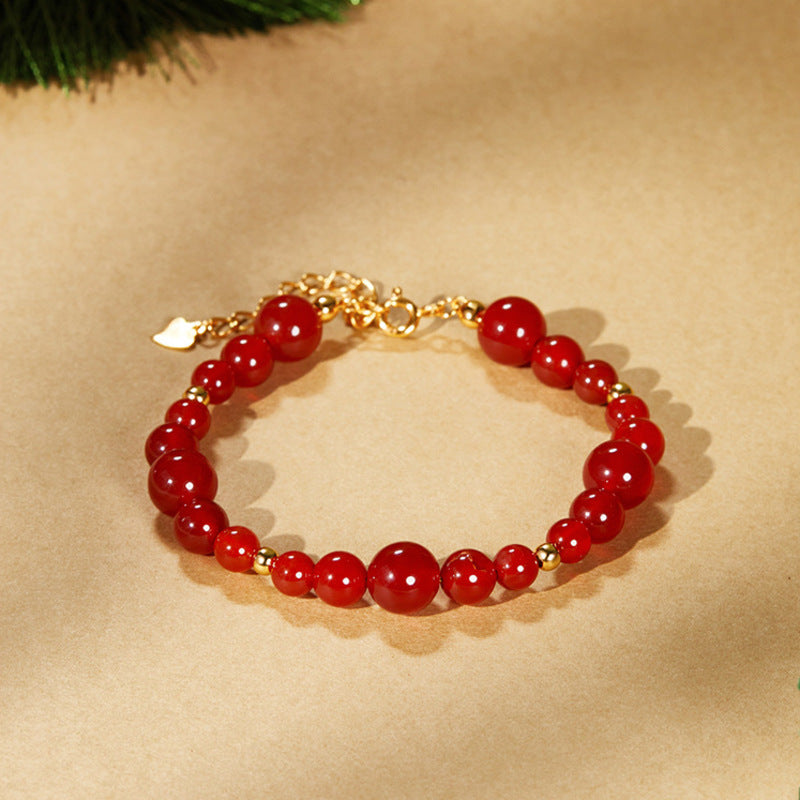 Red agate bracelet overhead view showing graduated bead sizes