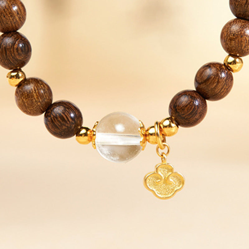 Close view of clear quartz bead and Ruyi charm