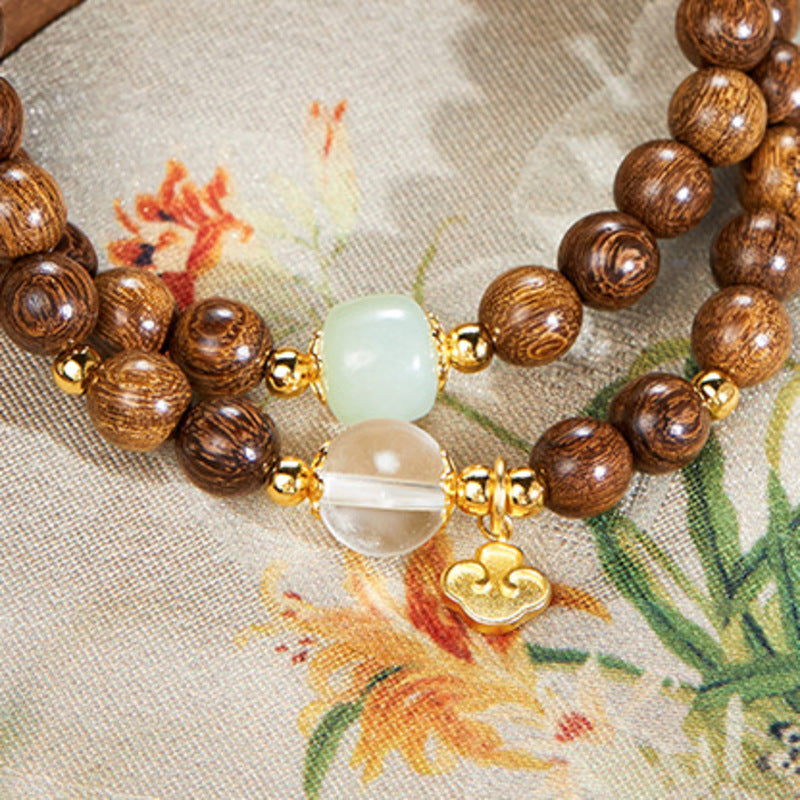 Nephrite jade, clear quartz and Ruyi charm detail