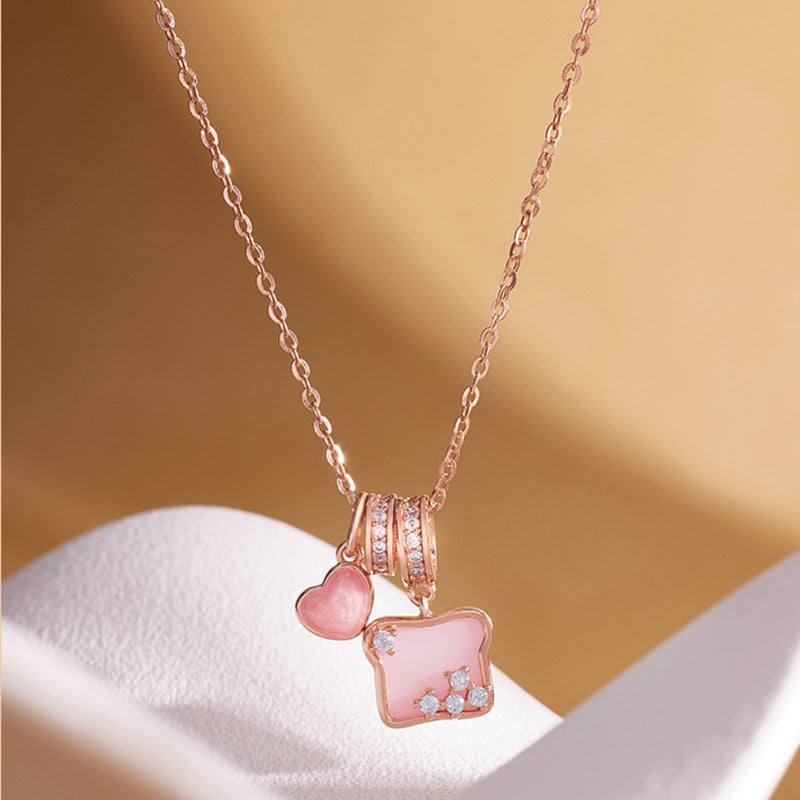 S925 silver pink shell toast heart necklace on warm background