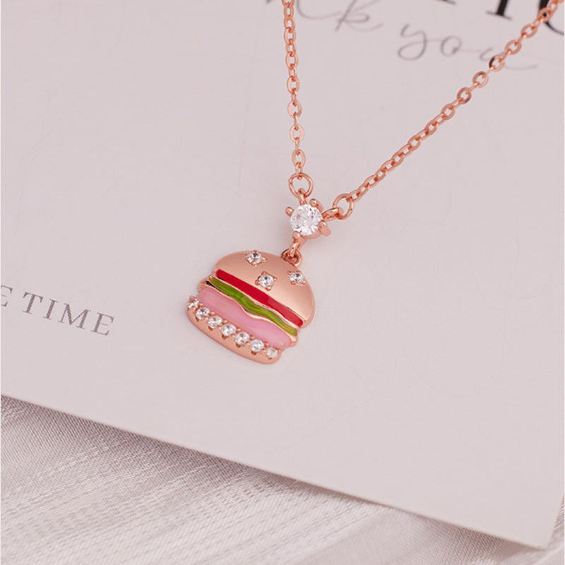 Angled view of S925 silver burger pendant necklace