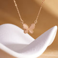 S925 silver textured butterfly necklace on a warm sculptural display