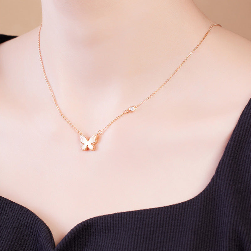 Front model view of the champagne-gold-color butterfly necklace