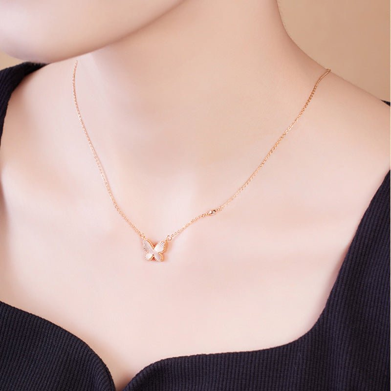 Side view of model styling the delicate butterfly necklace