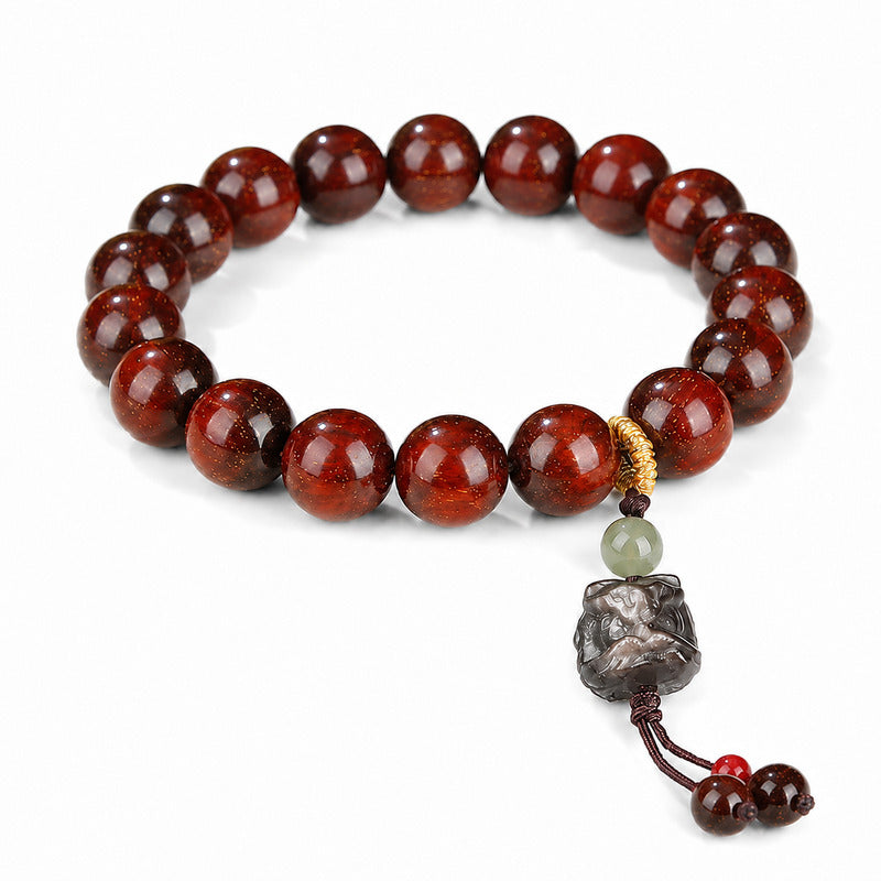 Sandalwood bead bracelet with silver obsidian lion dance head on white background