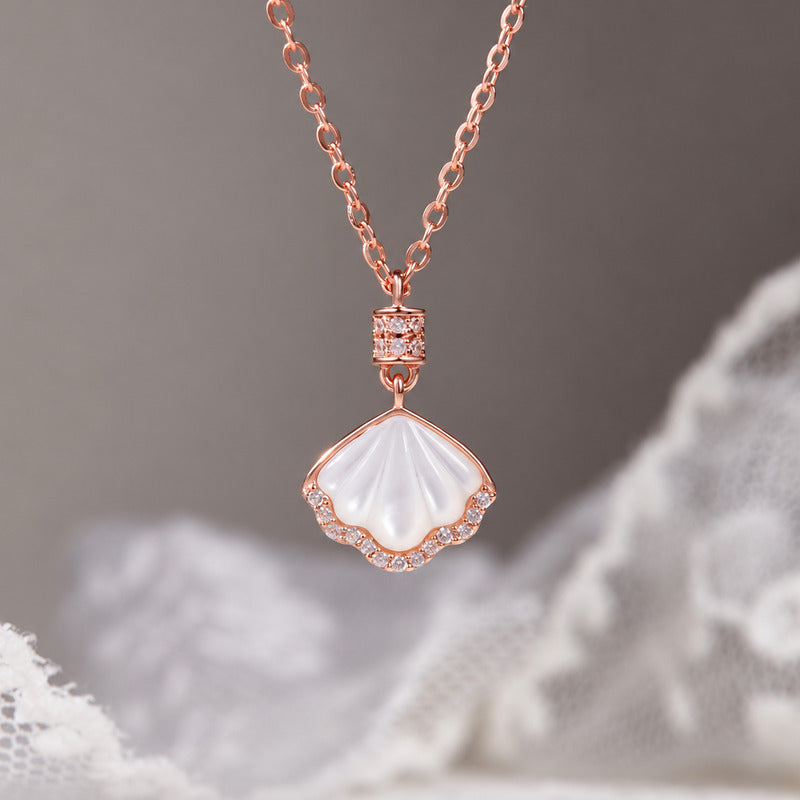 White mother-of-pearl shell necklace on a soft gray background