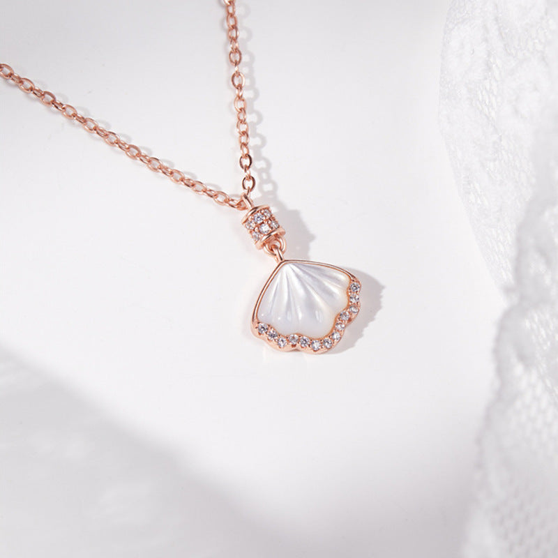 Rose-gold tone shell pendant detail