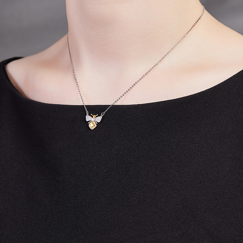 Original model wearing the bee necklace, side neckline view