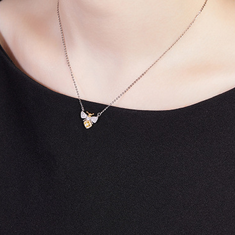 Original model wearing the bee necklace, close neckline view