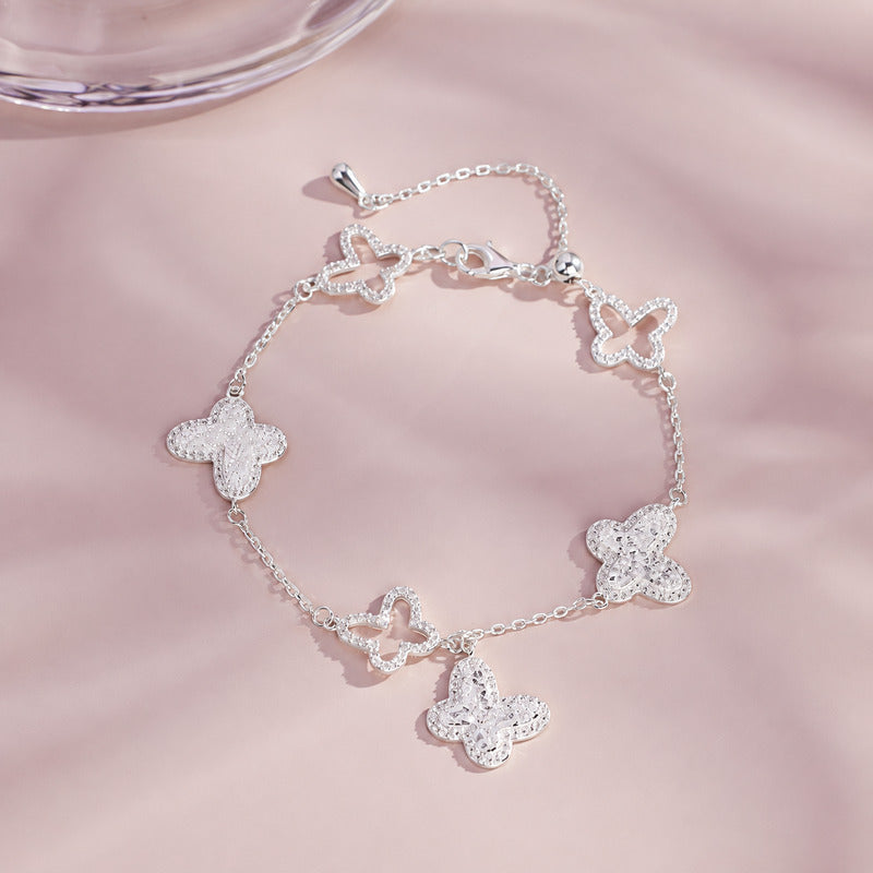 Sterling silver butterfly bracelet on pink background