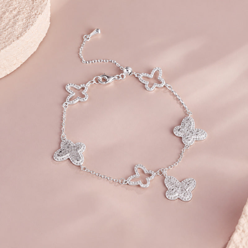 Silver butterfly bracelet - pink background alternate view