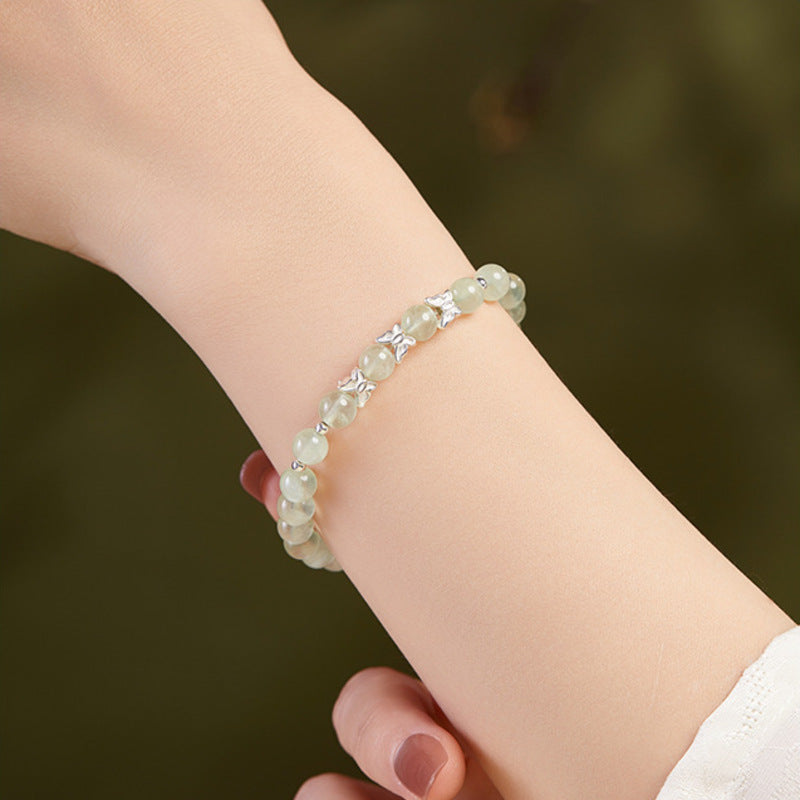 Prehnite and silver butterfly bracelet worn on the wrist