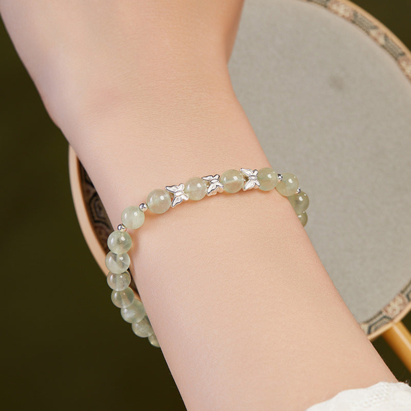 Prehnite and silver butterfly bracelet worn on the wrist