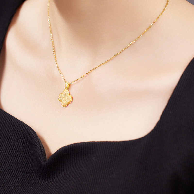 Side view of the original model wearing the four-leaf clover necklace