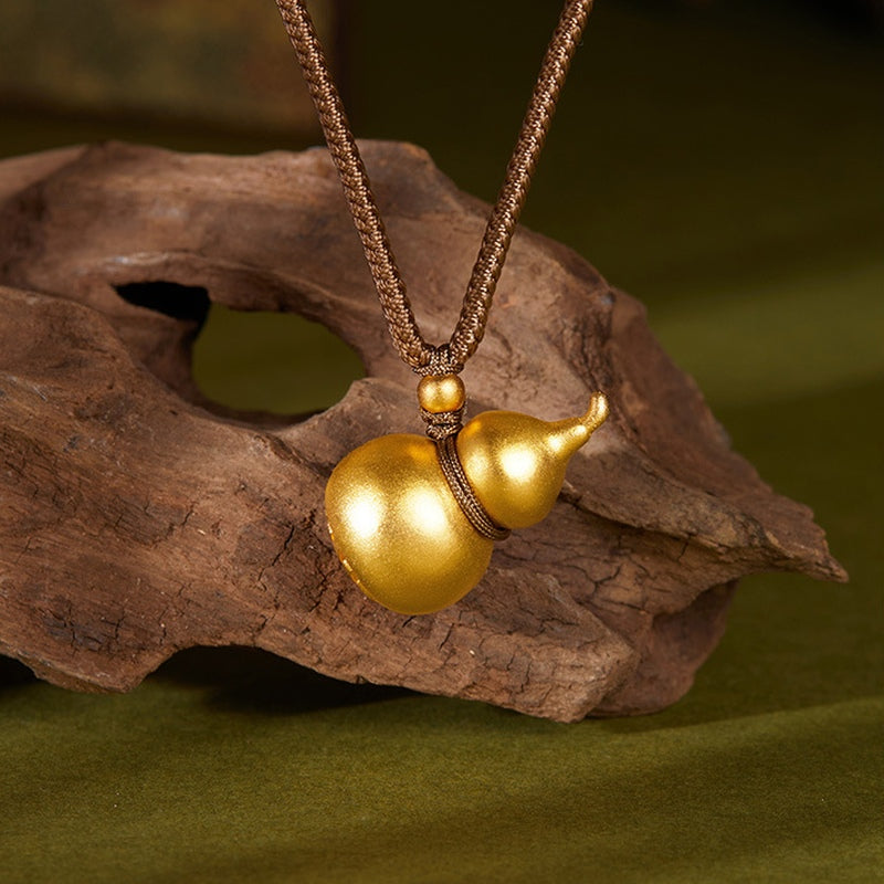Matte gourd pendant against natural wood