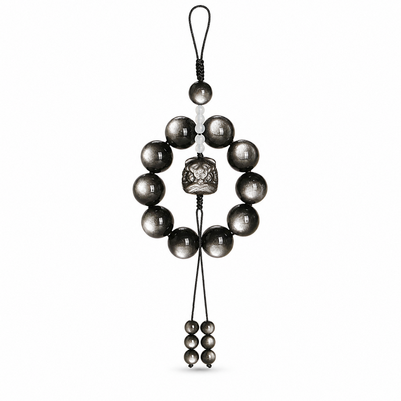 Silver obsidian Lion Dance car charm on white background