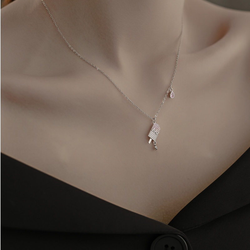 Original model wearing the silver popsicle necklace with a black neckline