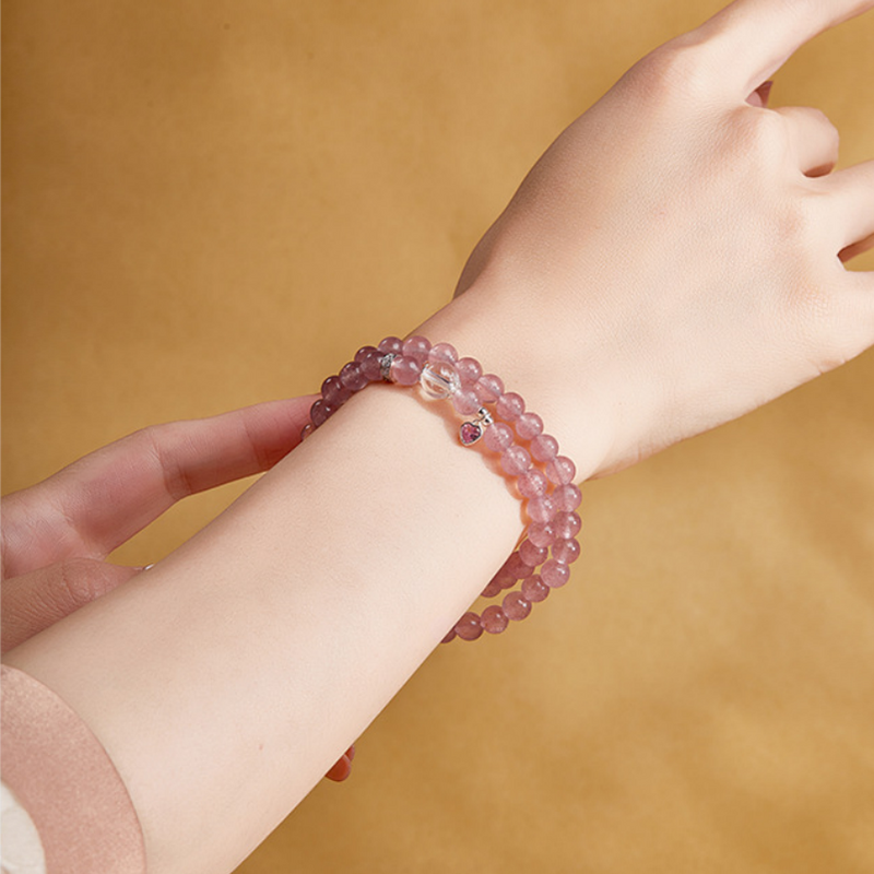Original model wearing the pink strawberry crystal heart bracelet wrapped twice around her wrist