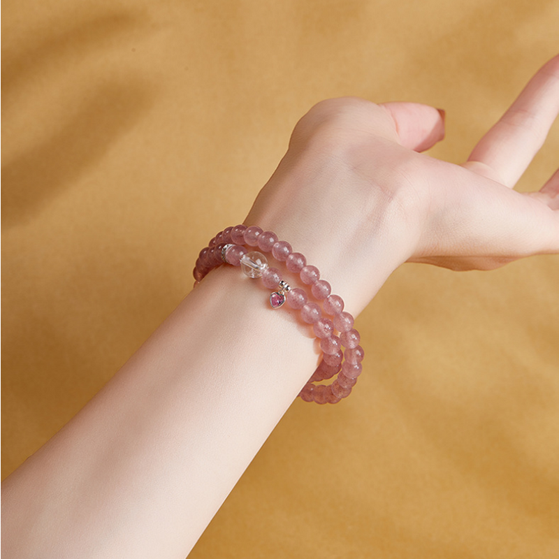 Second supplier wrist view showing the pink beaded bracelet worn in two wraps
