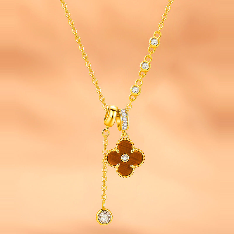 Tiger's Eye four-leaf clover necklace on warm peach background