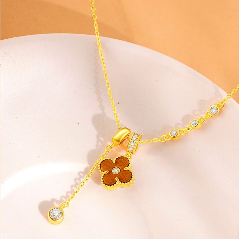 Tiger's Eye clover necklace arranged on stone detail