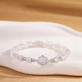 White chalcedony cloud bracelet on ivory display with silver details