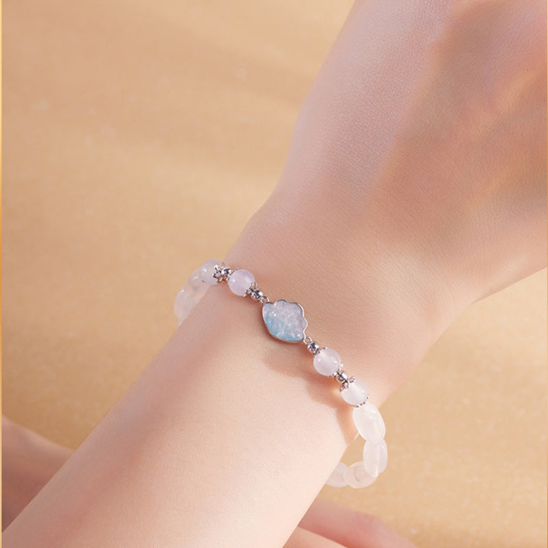 White chalcedony cloud bracelet worn on wrist in warm light