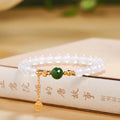 White chalcedony and green jasper bracelet with gold-tone coin charm