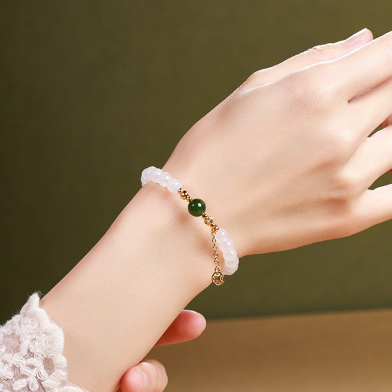 Close model view showing bracelet fit and coin charm detail