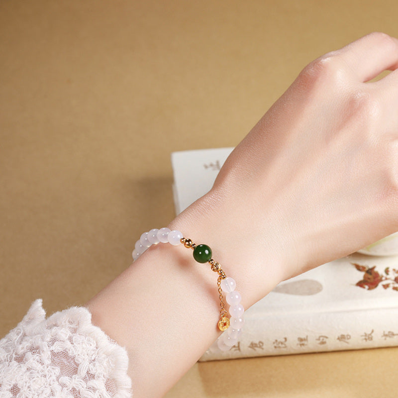 Model wearing white chalcedony bracelet with green jasper center bead