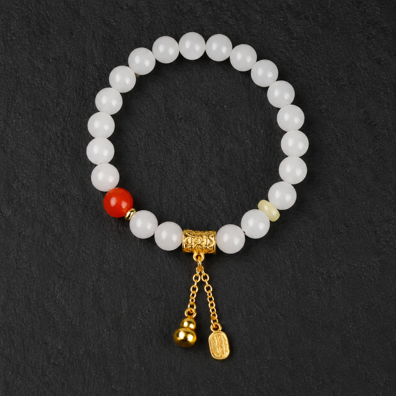 White jade gourd agate bracelet on dark stone