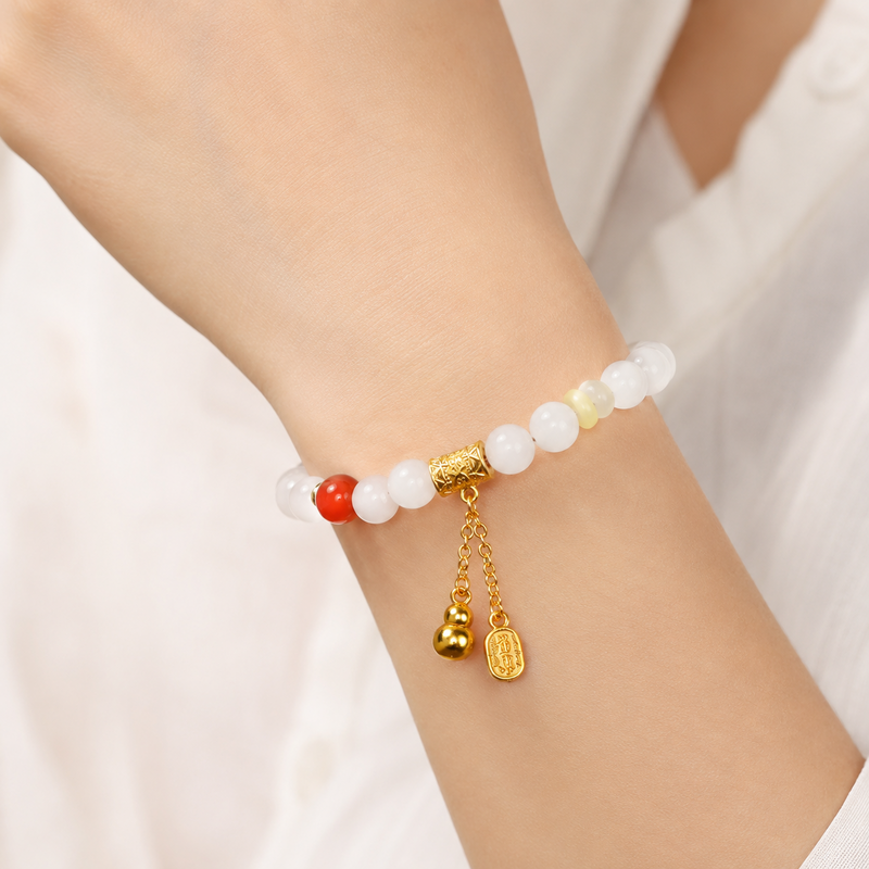 White jade gourd agate bracelet worn on a woman’s wrist